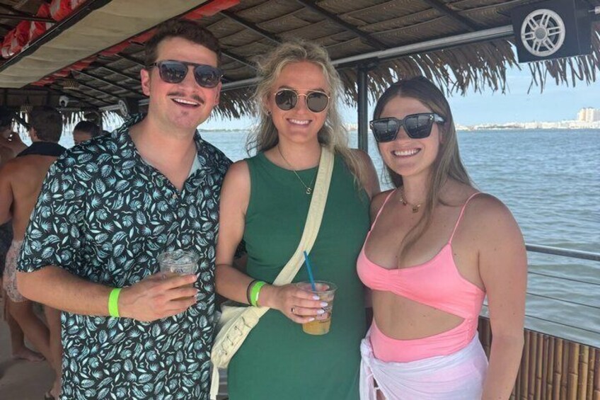 Three people on a boat with a water body in the background. 3