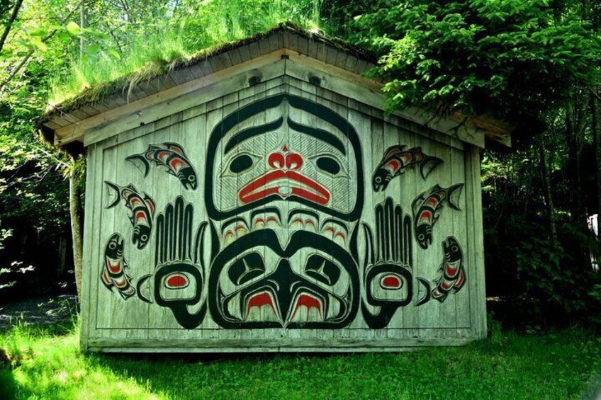 A totem pole with intricate carvings and a traditional design. 5