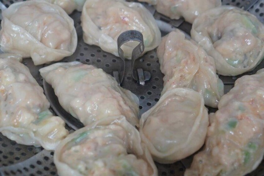 A steamer basket with dumplings. 3