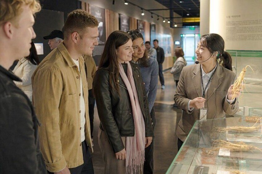 A museum exhibit with visitors observing an artifact. 3