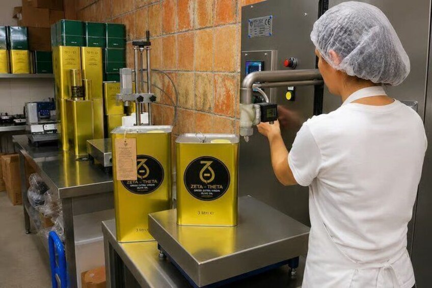 A person in a white uniform operating a machine with a yellow container labeled 'ZETA-THETA.' 5