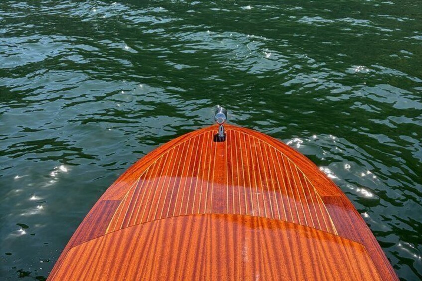 A wooden boat with a striped pattern on the water. 3