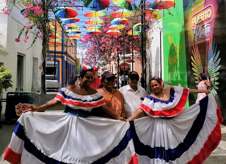 A street with colorful umbrellas and people in traditional dresses. 1