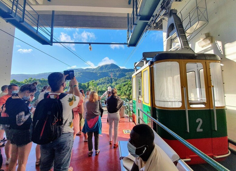 A cable car with passengers, a mountainous landscape, and a clear sky. 4