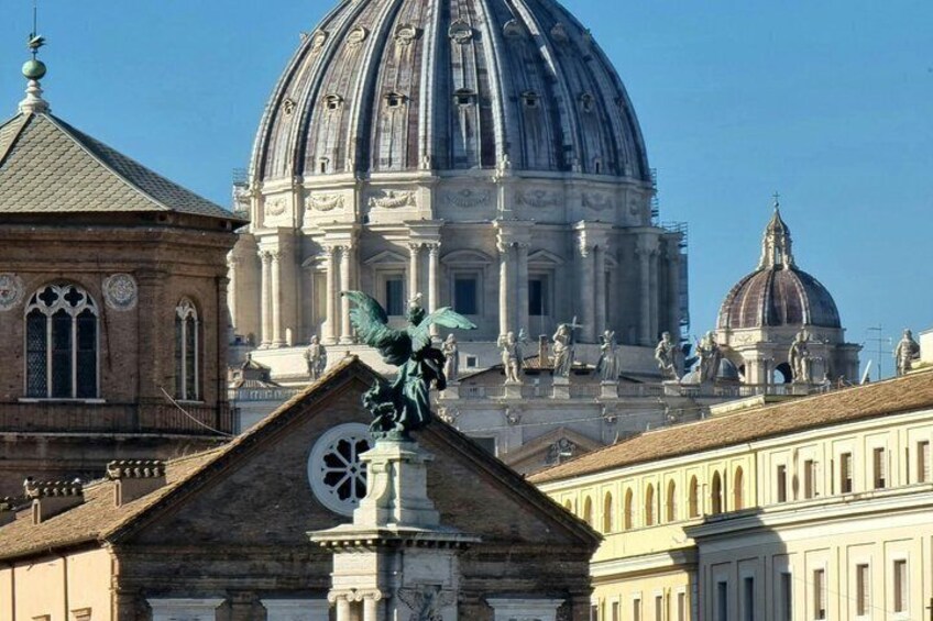 A large dome structure, a smaller dome, and a building with a statue. 2
