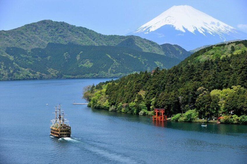 A boat on a lake with a mountain in the background. 4