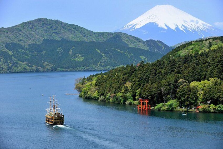 A boat on a lake with a mountain in the background. 4