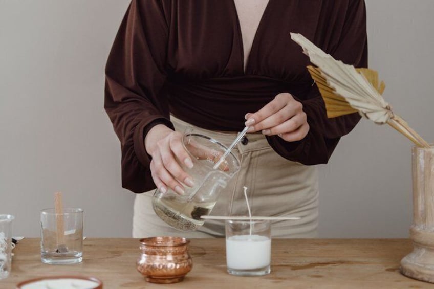 A person pouring a liquid from a measuring cup into a glass. 1