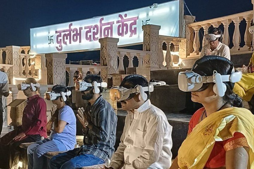 People wearing VR headsets at a center with a sign in a foreign language. 1