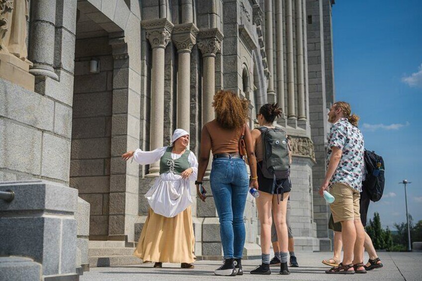 A group of people standing in front of a historic building with columns. 4
