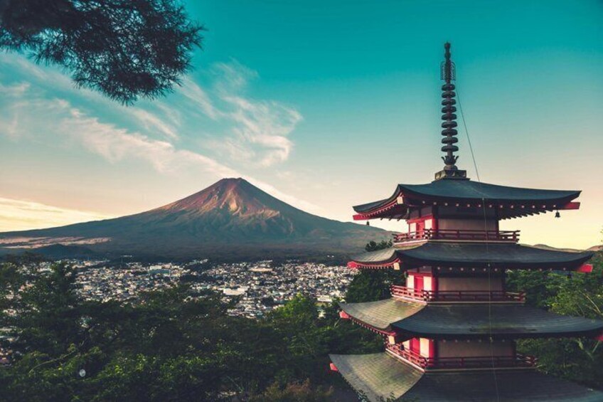 A pagoda, a mountain, and a town in the background. 1