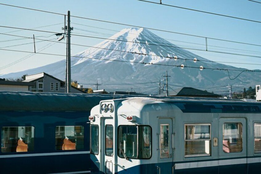 A train with a view of a snow-capped mountain in the background. 2