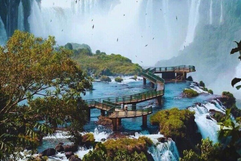 A waterfall with a bridge and a river. 3