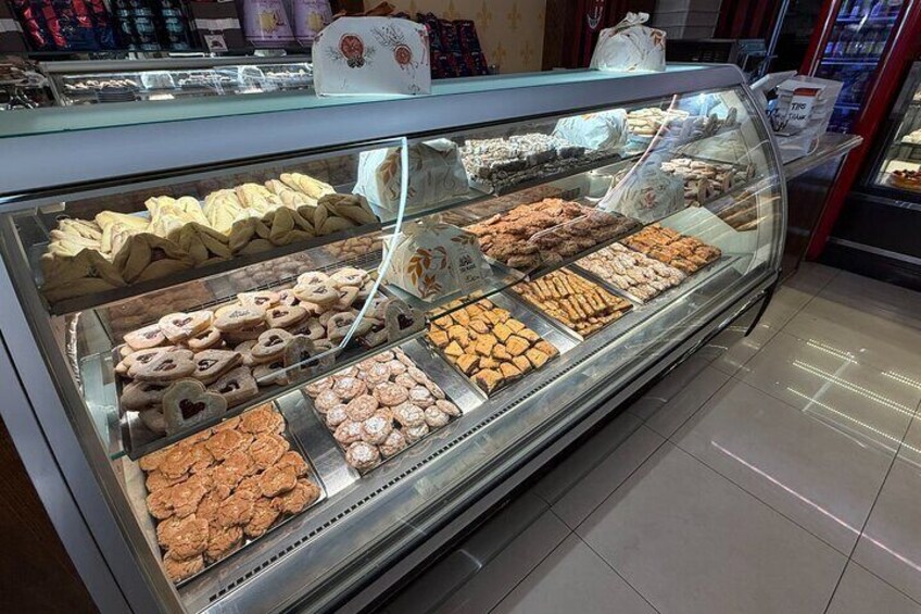 A bakery display case with various baked goods. 3