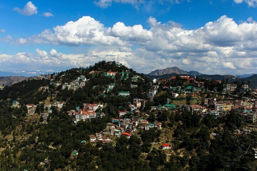 A mountainous town with colorful buildings nestled among trees. 3