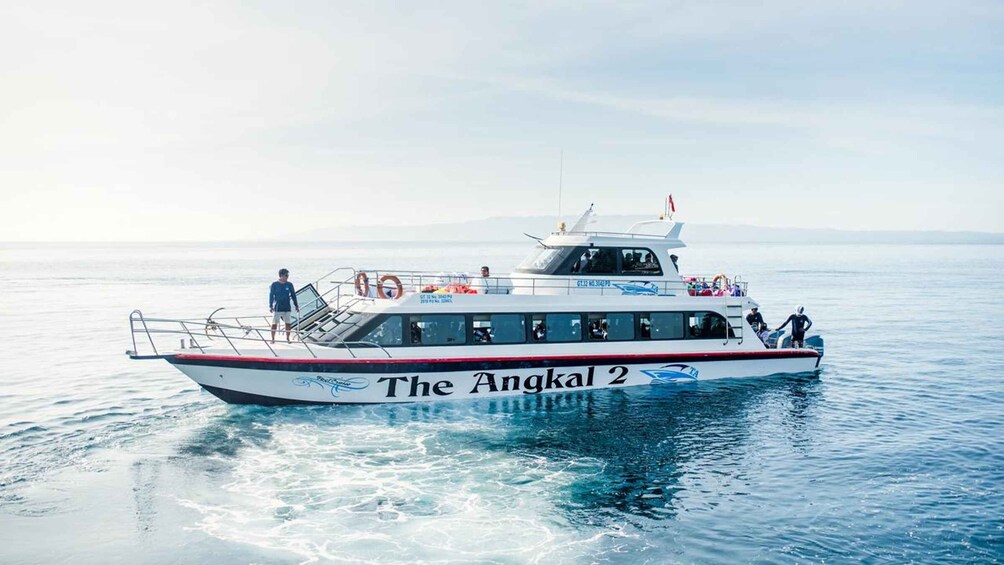 A boat named 'The Angkal 2' on calm water. 4