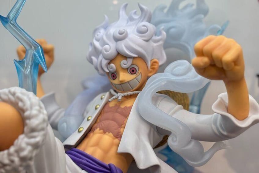A detailed action figure with a white outfit and a blue background. 5
