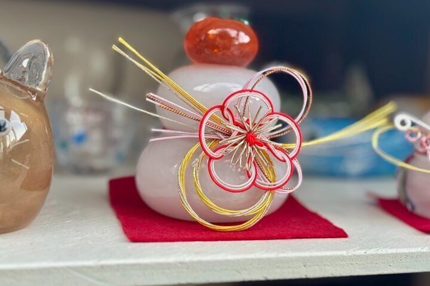 A piggy bank with a red bow and a glass jar with a red lid. 3