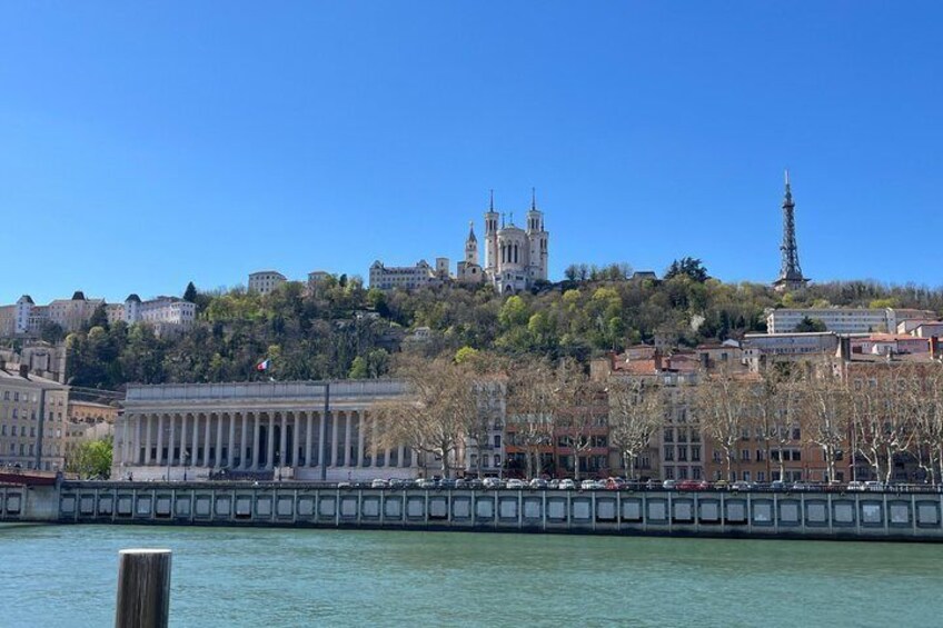 A cityscape with a prominent cathedral, a statue, and a river. 3