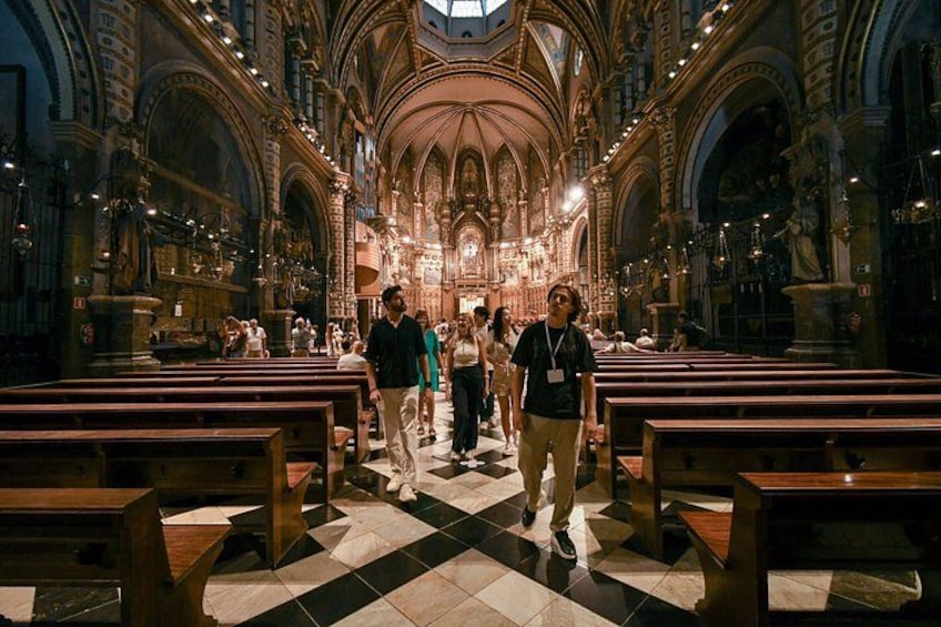 A church interior with high arched ceilings, wooden pews, and a central altar. 3