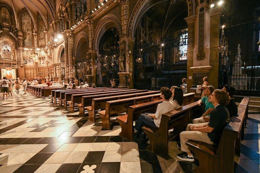 A church interior with pews, a checkered floor, and ornate architecture. 4