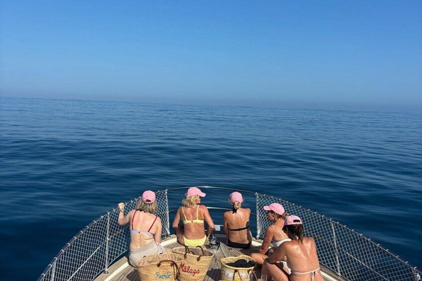 A group of people on a boat in the middle of a large body of water. 4