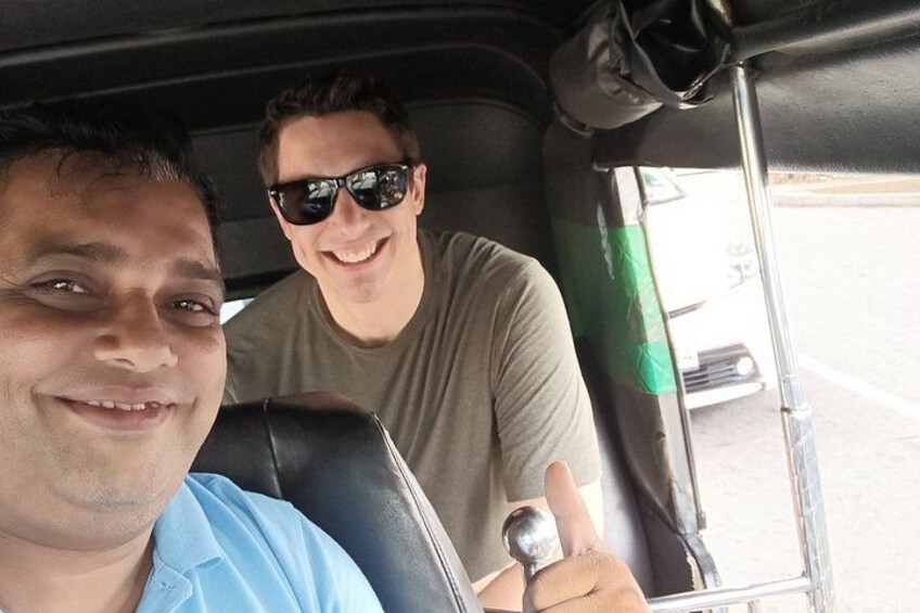 Two people in a vehicle with a window and a door. 1