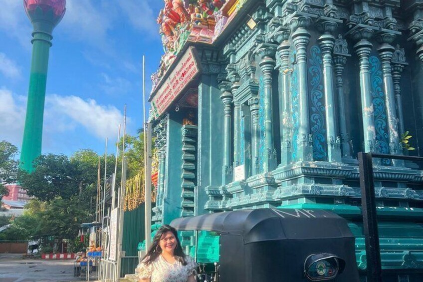 A traditional temple with ornate columns and a green spire. 2