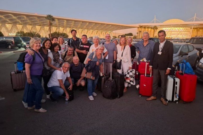 A group of people with luggage in an airport terminal. 2