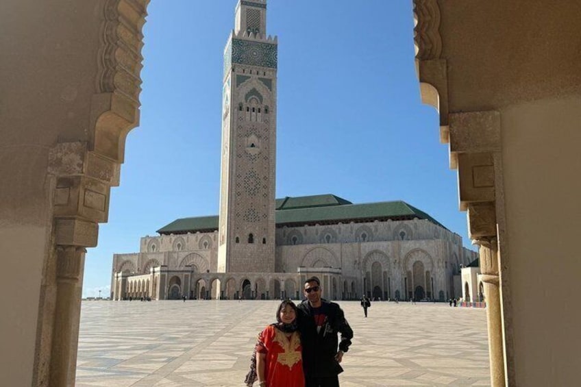 A historic building with a tall minaret and arched doorways. 5