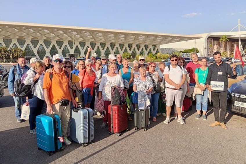 A group of people with luggage at an airport terminal. 3