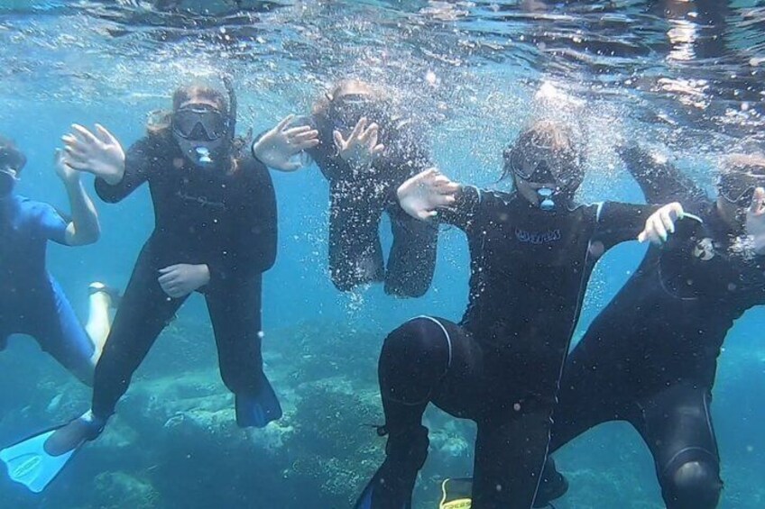 A group of people scuba diving underwater. 1