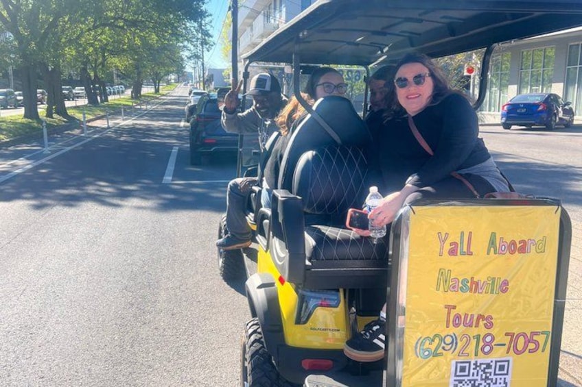 A yellow vehicle with a sign advertising tours in Nashville. 3