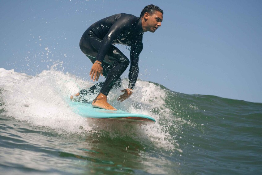 A person surfing a wave in the ocean. 3