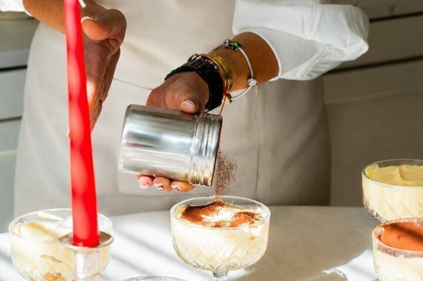 A person pouring a liquid from a shaker into a glass. 5
