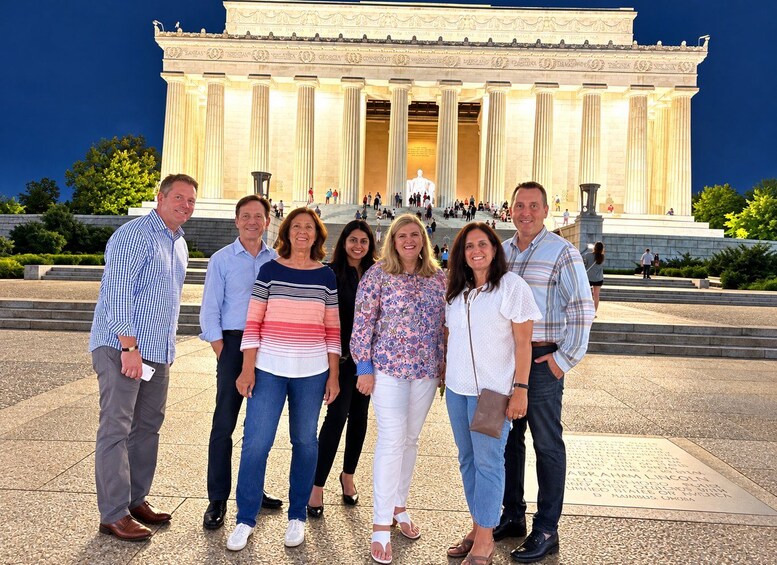 A group of people standing in front of the Lincoln Memorial. 2