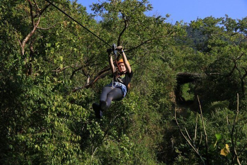 A person zip-lining through a forest. 4
