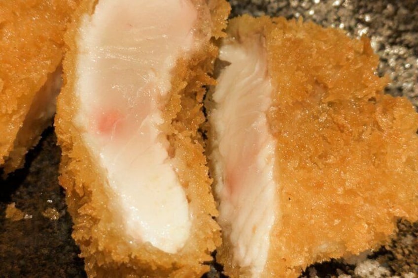A close-up of a breaded and fried food item, likely a croquette or similar bite-sized dish. 5