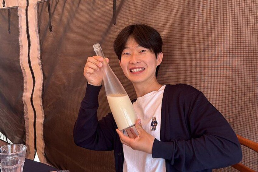 A person holding a bottle with a liquid. 3