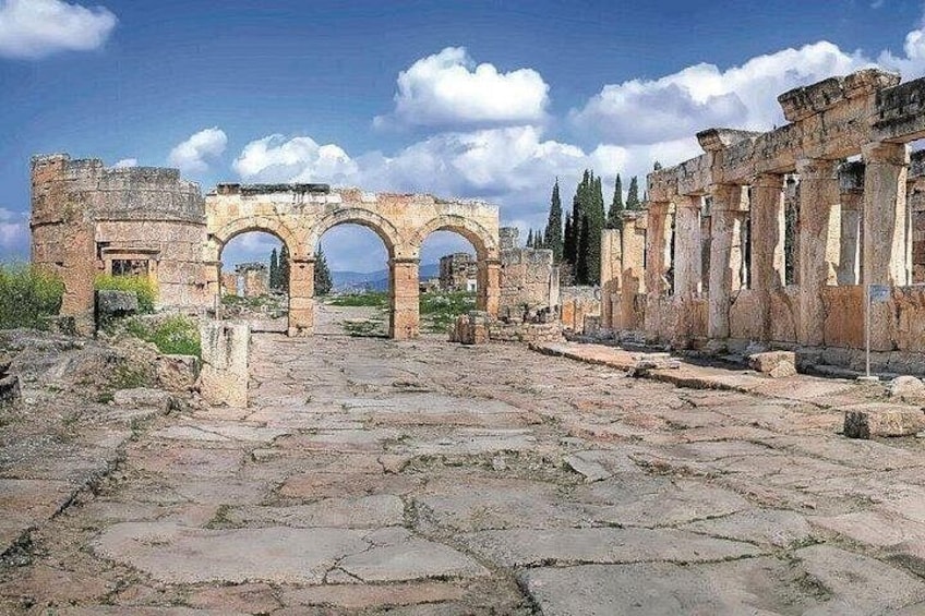 Ancient ruins with stone pathways and arches. 4