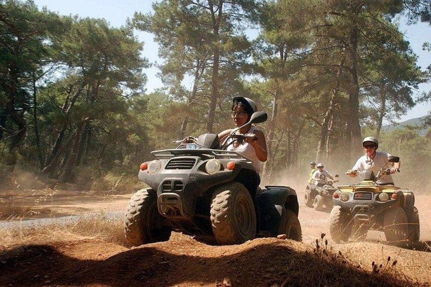 Off-road vehicles on a dirt path surrounded by trees. 3