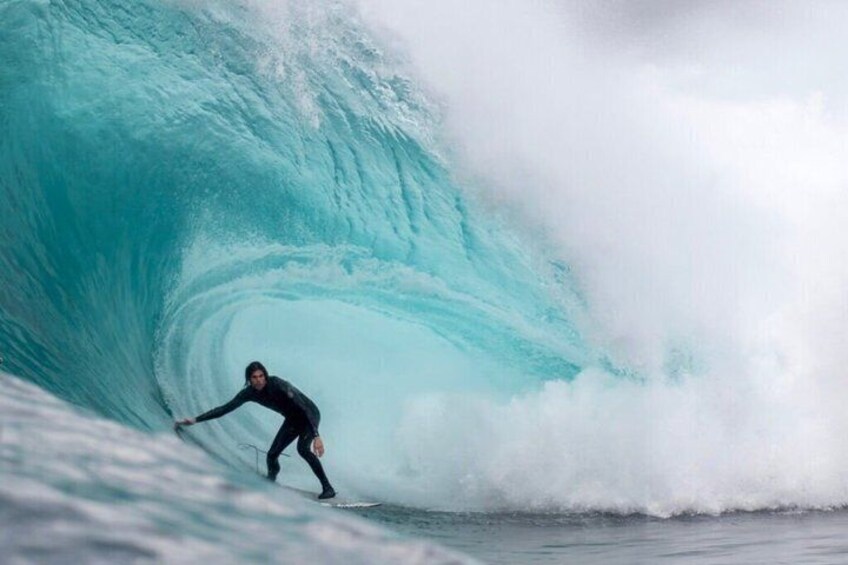 A surfer riding a large wave. 1