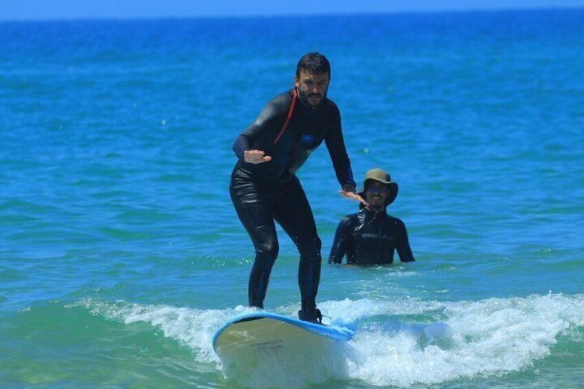 A person surfing on a wave in the ocean. 5