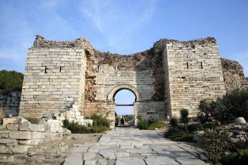 Ancient ruins with a large stone archway. 4
