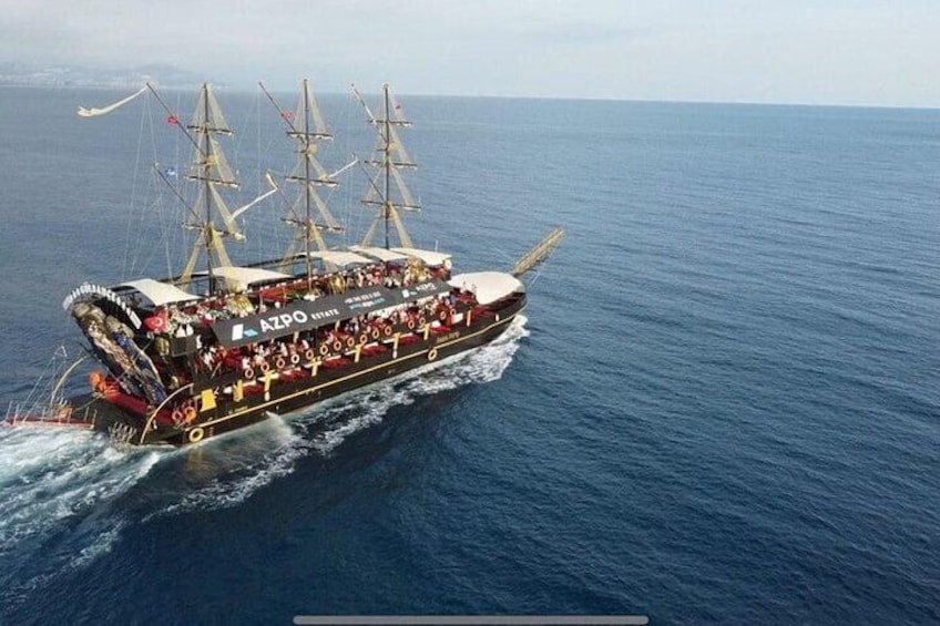 A large ship with multiple decks sailing on the ocean. 5