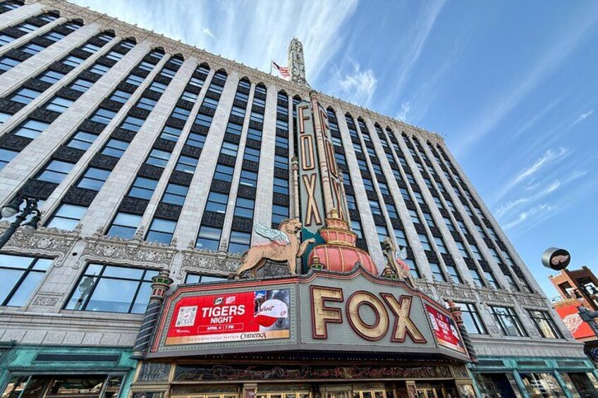 A large building with a prominent 'FOX' sign and a 'TIGERS NIGHT' advertisement. 5