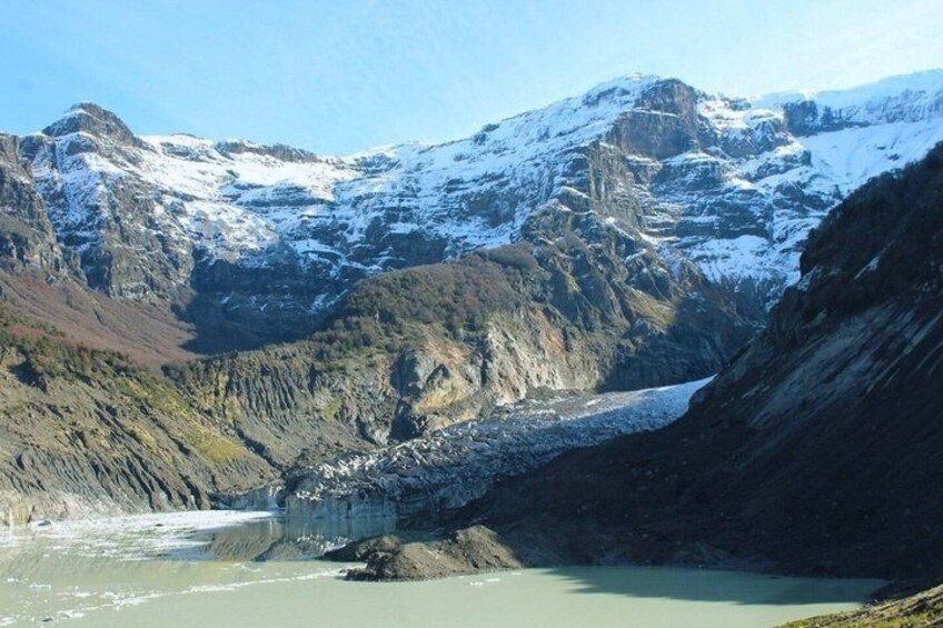 A glacier with a lake in a mountainous valley. 3