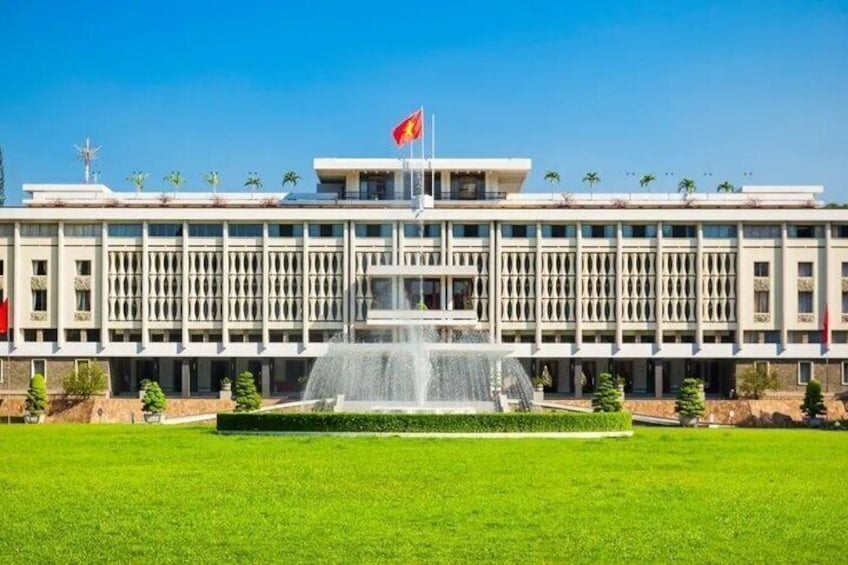 A large building with a flag, a fountain, and a well-maintained lawn. 3
