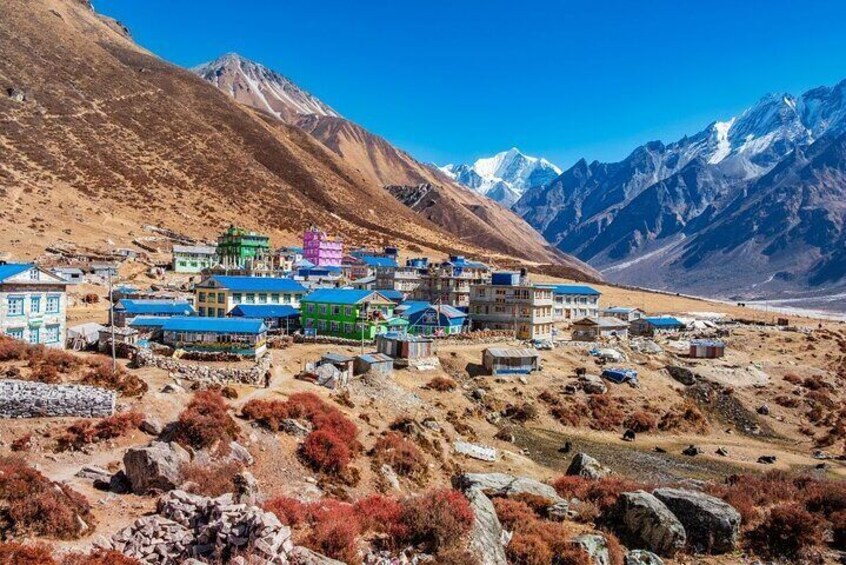 A mountainous village with colorful buildings and a clear sky. 1