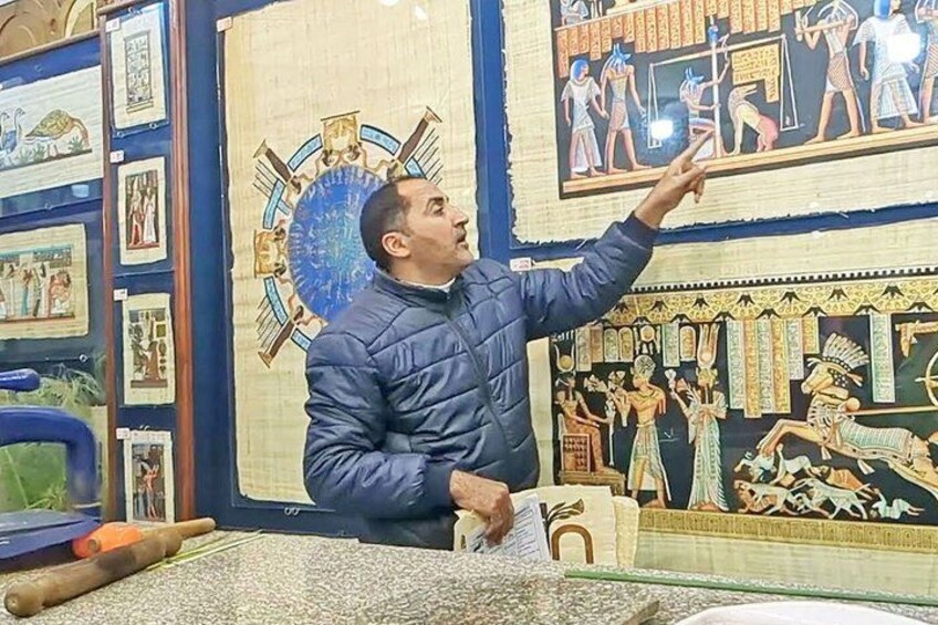 A person examining ancient Egyptian wall paintings. 2